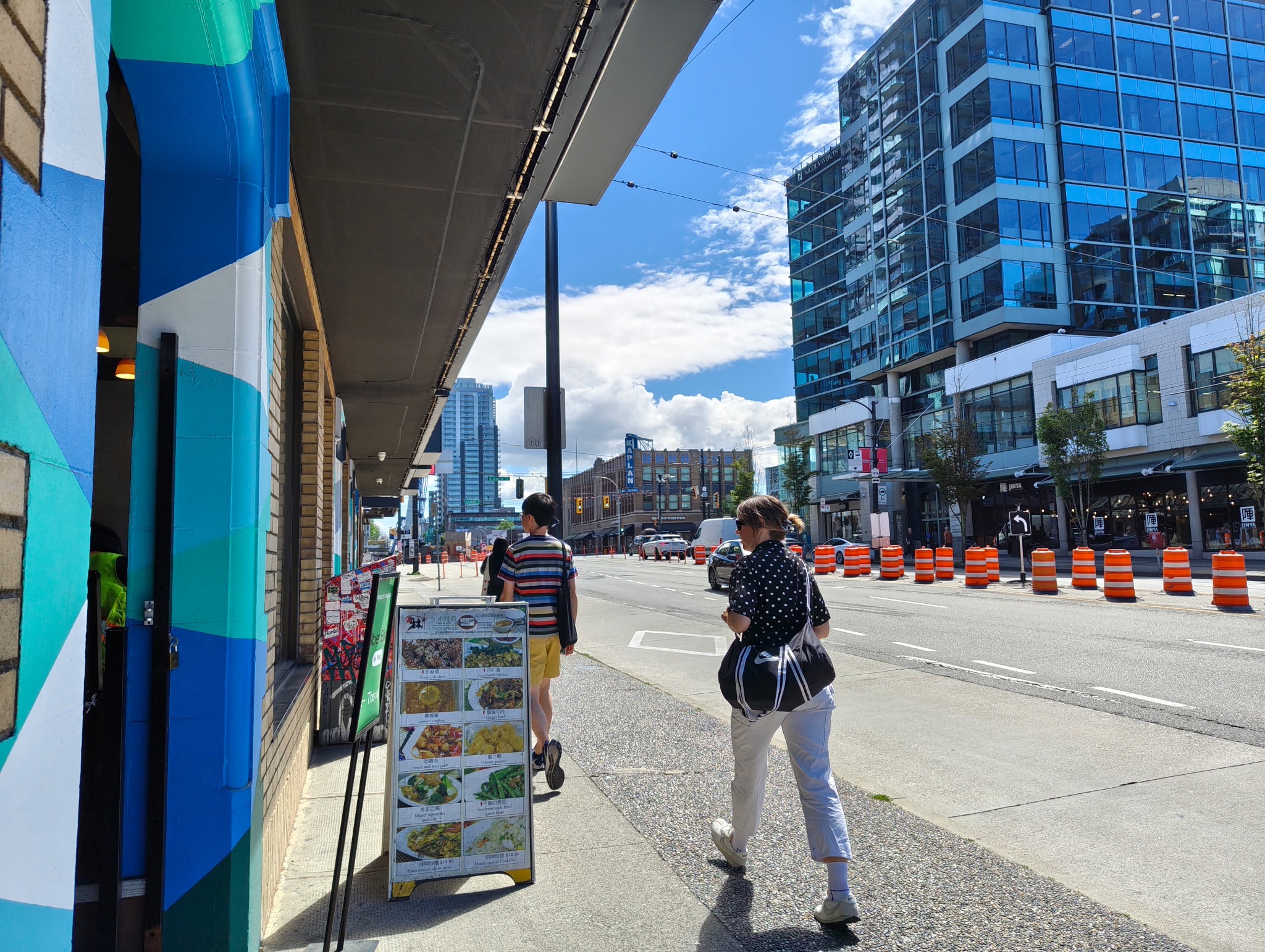 Pedestrians walk along W. Broadway near Granville Street during road reconstruction work. 